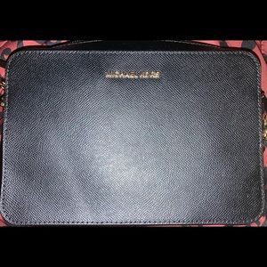 Black cross body with gold link parts on the strap